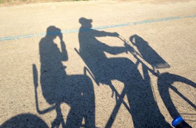 Shadow of people on road