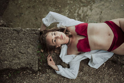Portrait of woman lying down outdoors