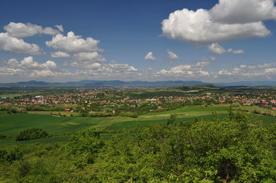 Scenic view of grassy field against cloudy sky