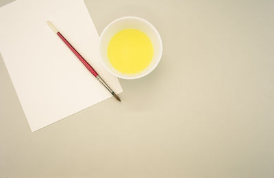 High angle view of cup and spoon on white background