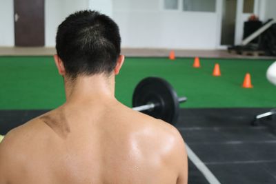Rear view of shirtless man in gym