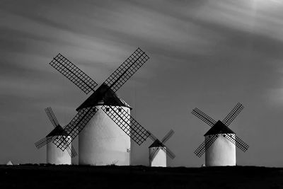 Low angle view of windmill on landscape against the sky