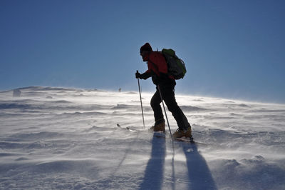 Full length of man standing on snow covered landscape