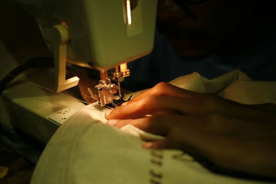 Cropped image of person using sewing machine