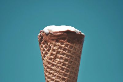 Close-up of ice cream against blue sky