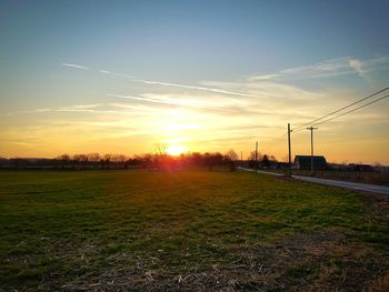 Scenic view of field against sky during sunset