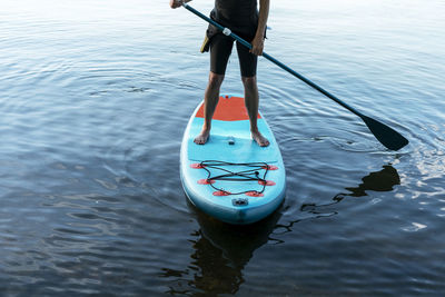 Man kayaking in sea