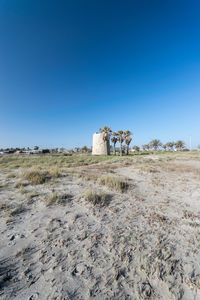 Scenic view of land against clear blue sky