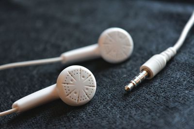 Close-up of in-ear headphones on table