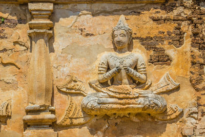 Buddha statue against historic building
