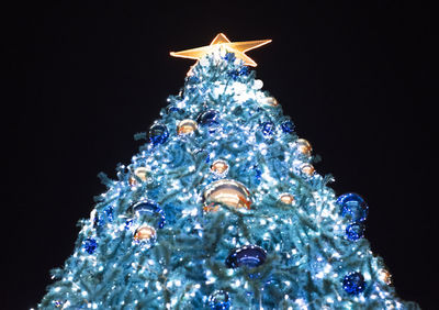 Low angle view of illuminated christmas tree at night