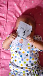 Midsection of woman holding pink text