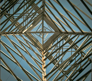 Directly below shot of electricity pylon against sky