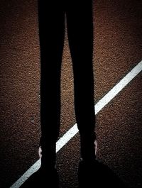 Low section of man standing on tiled floor