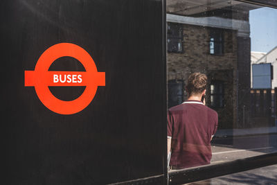 Rear view of man on road sign