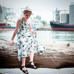 Full length portrait of young woman in water