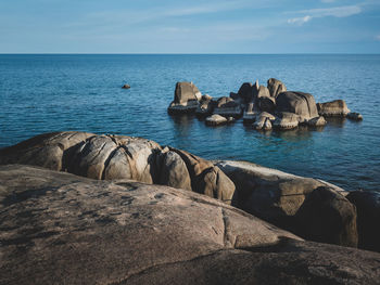 Scenic view of rock formation bay with blue water against sky. hin ta hin yai, koh samui, thailand.