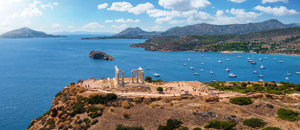 Scenic view of sea and mountains against sky