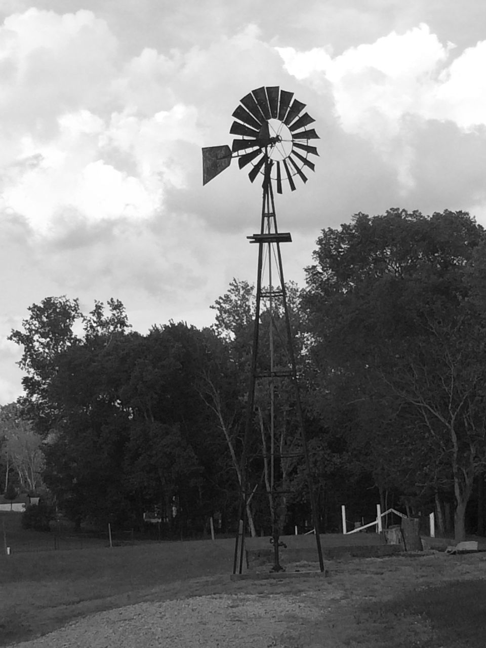 tree, windmill, wind power, sky, environmental conservation, wind turbine, alternative energy, renewable energy, fuel and power generation, low angle view, cloud - sky, technology, traditional windmill, field, cloudy, landscape, tranquility, cross, nature, cloud