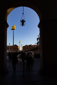 People on street amidst buildings in city
