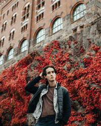 Portrait of man standing in city during autumn