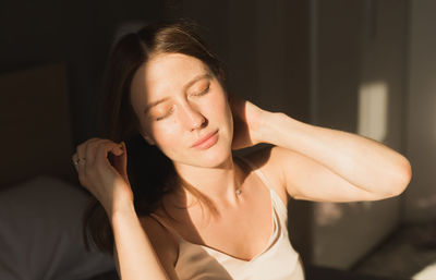 Portrait of young woman sitting at home