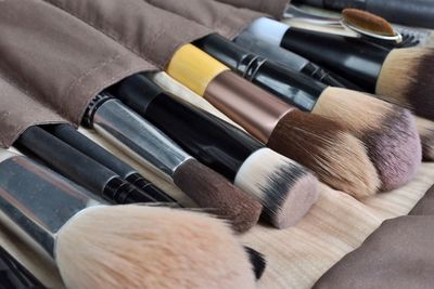 Close-up of make-up brushes on table
