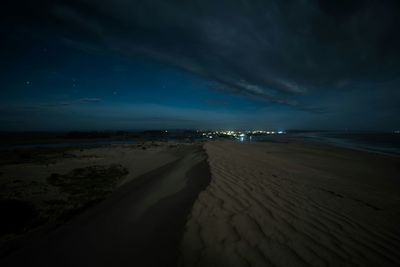 Scenic view of beach against sky at night