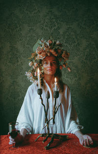 Portrait of woman standing against wall