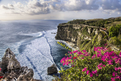 Panorama on uluwatu temple high cliffs at sunset, bali, indonesia