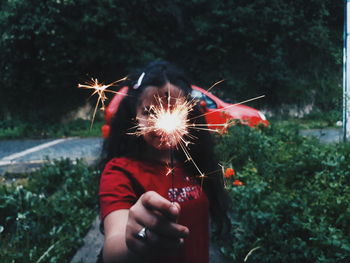 Close-up of hand holding sparkler