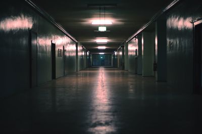 Empty illuminated corridor in building