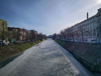 Road amidst buildings against sky in city