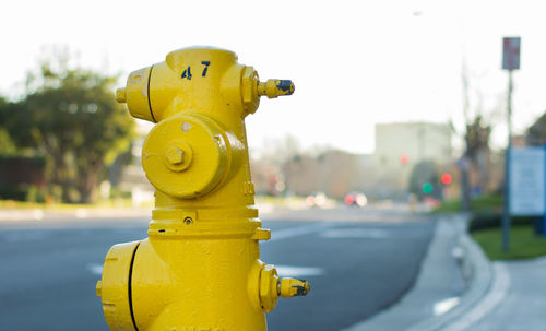 Close-up of yellow fire hydrant against sky
