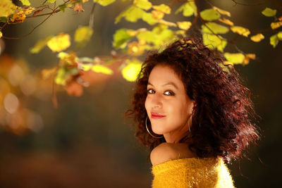 Portrait of young woman standing outdoors