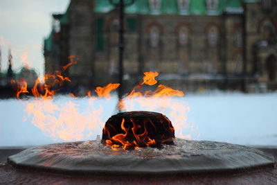 Close-up fire with building in background