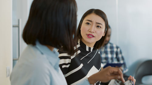 Businesswoman talking with colleague in office