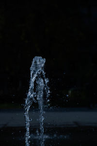 Close-up of water splashing against black background