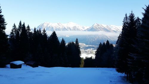 Scenic view of snowcapped mountains against clear sky