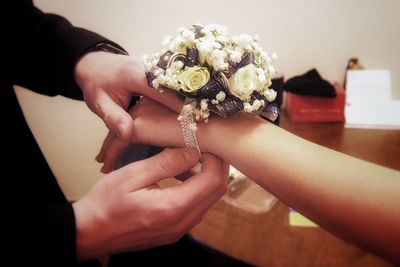 Close-up of hand holding rose bouquet