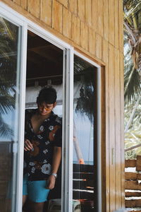 Woman looking through window