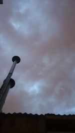 Low angle view of silhouette built structure against sky