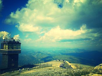 Scenic view of mountains against cloudy sky