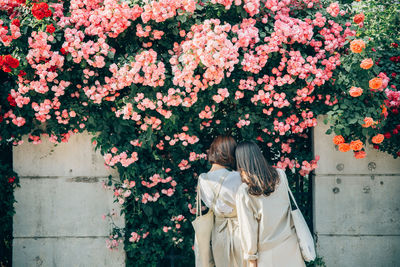 Woman standing by flowering plants