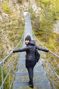 Portrait of woman walking on footbridge