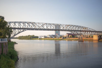 View of bridge over river against clear sky