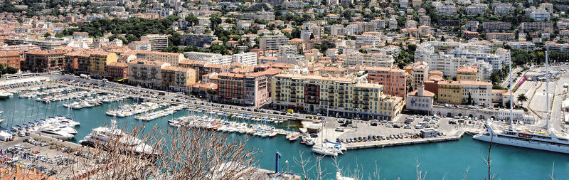 High angle view of boats moored at harbor in city