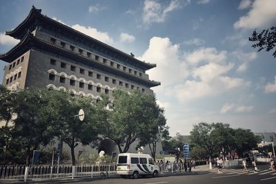 Low angle view of building against cloudy sky