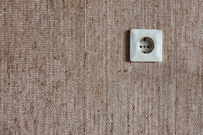 Close-up of electric fan on wall