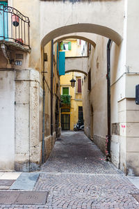 Empty alley amidst buildings in city